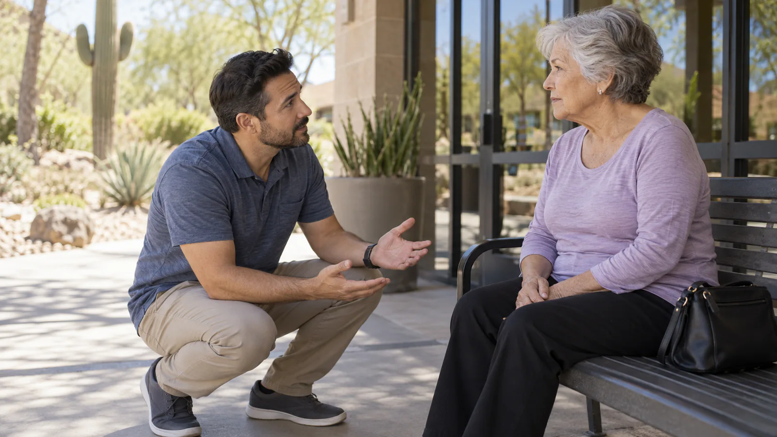 A respectful adult asks an alert older woman for permission before helping.